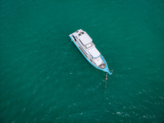 Aerial photo of an isolated luxury white  yacht design in the sea.