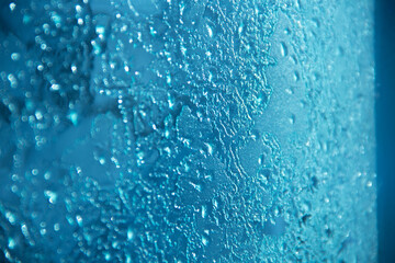 Frozen pattern. Melting ice on the window.
