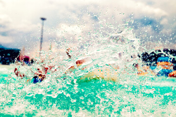Water park adventure aqua park with cool people having fun on the water slide with friends and...