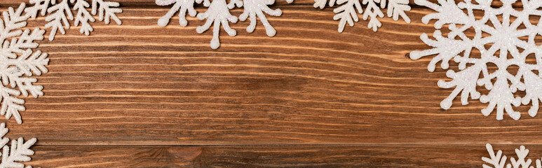 top view of winter snowflakes on wooden background, 