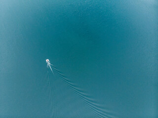 Speed boat quickly floating on the water surface and leaving a trail on the sea. Summer vacation holidays in Thailand. shooting from the gyrocopter side view