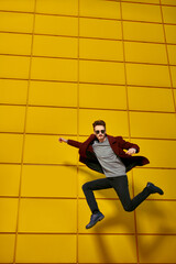 jumping man in a coat