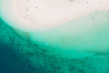 Aerial view of drone. Beaches and shops for food and beverage services on Khai Island, Phuket, Thailand, Seawater clear and blue green. Nature in Khai Island. At Khai island, Phuket, Thailand.