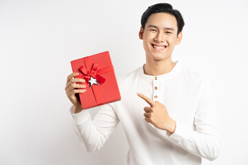 Asian businessman is holding red gift box on white background