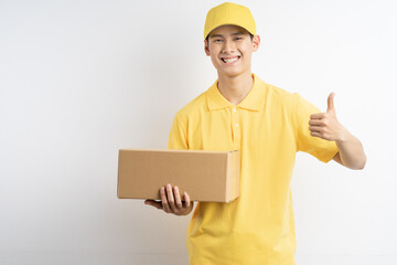 Photo of asian courier holding parcel on white background