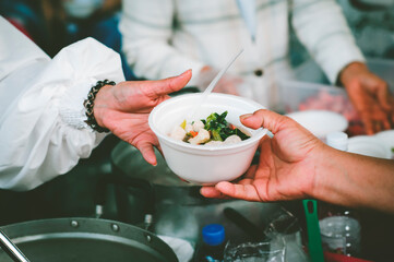 Volunteers Share Food to the Poor to Relieve Hunger: Concept poverty and donation