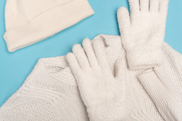 top view of winter white knitwear on blue 