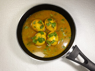 Close-up view of cooked chicken eggs in bowl on white cloth background