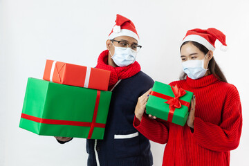 young couple asian wearing sweater giving present gift boxes for season greeting christmas and new year happy time on a white background
