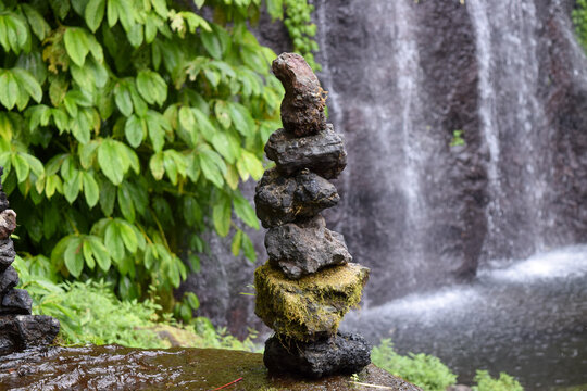 A balancing stone in the middle of a waterfall