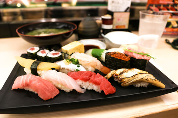 Mixed sushi set on a black plate, Japanese food.