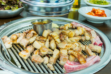 Korean food, grilled pork barbecue on hot metal plate looks tasty and delicious