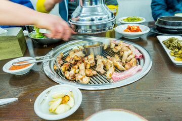 Korean food, grilled pork barbecue on hot metal plate looks tasty and delicious