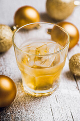 Whiskey on the rocks with winter christmas decorations. Selective focus. Shallow depth of field.