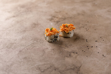 Appetizing rolls on a textured background. Japanese food concept. Close-up. Copy space.