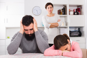Mother telling off her husband and daughter for disobedience at home