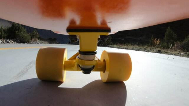Riding skateboard on high altitude mountain trail