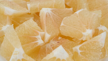 chopped citrus sweetie fruit in white plate close up