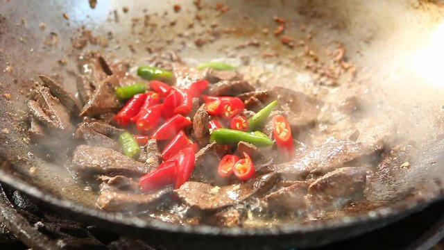 Frying pork liver with chili in pan, Chiangmai Thailand