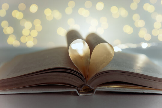Heart from book pages. vintage style with bokeh in soft light at night ,blur background, copy space, concept for valentine's day.