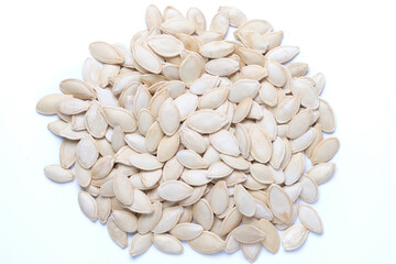 Raw dried pumpkin seeds isolated on white. Heap of pumpkin seeds