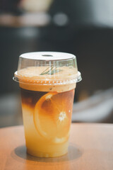 Espresso shot mix with orange soda decoration with large slice orange in inside.