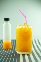One fresh orange juice bottle with tasty drink