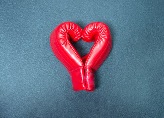 Gym background and fitness equipment and valentine concept. Boxing glove in shape of heart.