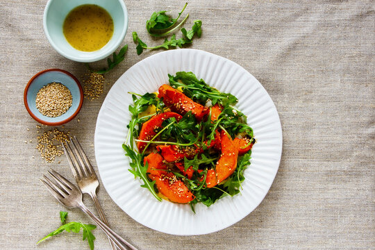 Sesame seed pumpkin with arugula salad