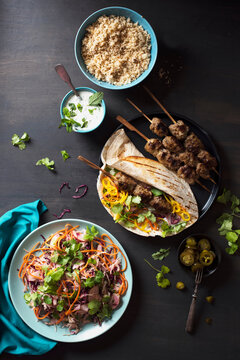 Lamb koftas with wrap, minted yoghurt, crunchy salad with coriander and jalapenos