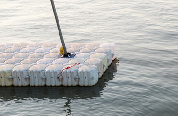 The small white plastic pontoon for the travel boat.