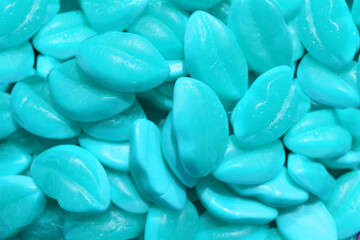 Colorful texture using as background. A lot of sweets. Background 3d rendering illustration. Orange and black multiple jelly candies in powdered sugar. Confectionery wallpaper concept. Copy space