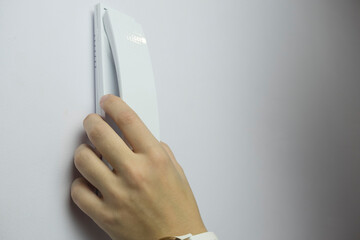 woman who uses a home intercom to let a guest or family member into her apartment