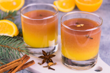 Mulled wine with orange juice and spices is decorated with a New Year's composition.