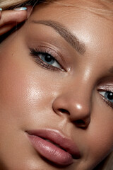 Close-up portrait of a beautiful woman with blue eyes . Strong skin texture. Natural makeup, clean...