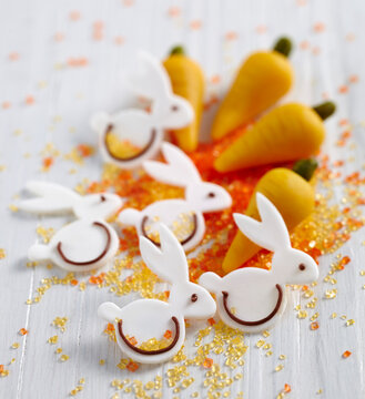 Edible Easter decorations: marzipan carrots and fondant bunnies with coloured sugar