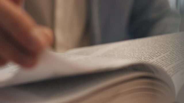 Unrecognizable lawyer's hand works with papers and law books in courtroom or office. Concept of justice and law, attorney or court judge