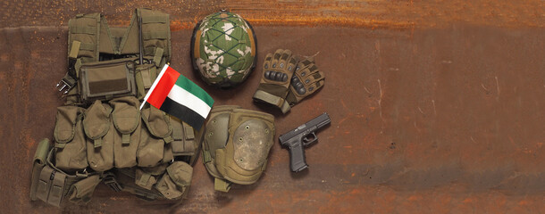 Fototapeta na wymiar UAE National Holidays Concept. Flag and military uniform on rustic background. Mohammedan prayer