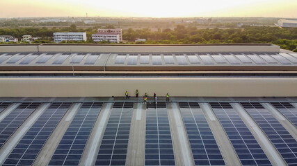 Solar panels installed on a roof of a large industrial building or a warehouse. Industrial...