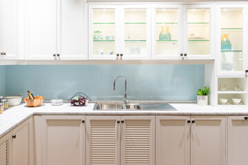 Kitchen Interior with Island, Sink, Cabinets, and Hardwood Floors in New Luxury Home