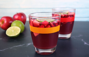 Closeup Chilled Red Wine Sangria on the Table with Blurry Fresh Fruits in the Background
