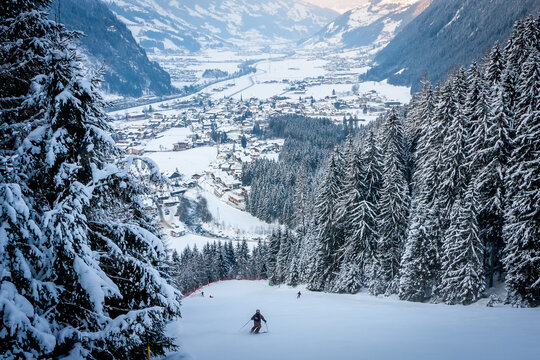 Winter landscape in the Alps. Frosty sunny day. Spruce covered with snow and frost on the background of the mountains. Panoramic view of Mayrhofen, Austria. Zillertal valley