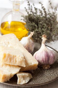 Pieces of parmesan, garlic, olive oil and thyme