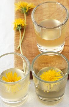 Homemade dandelion schnapps with fresh flowers