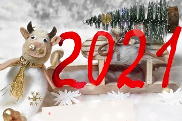 Christmas decoration. White background, close-up. Numbers 2021 and the symbol of the year of the cow 