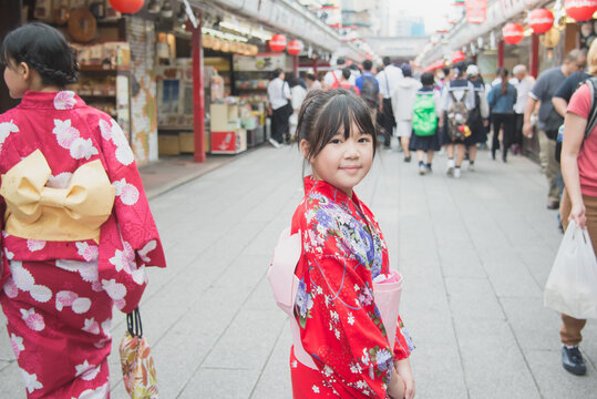 Beautiful Asian girl wearing red kimono  walking in the city,Asakusa Tokyo Japan.