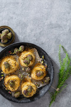 Easter eggs coated in dates, cocoa and pistachios in angel hair pasta nests