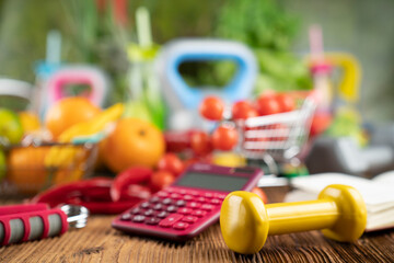 Fitness concept. Healthy nutrition: fruits and vegetables. Equipment for fitness exercises: weighing machine and dumbbells. 
