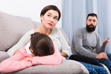 Young father lecturing his wife and daughter for disobedience at home