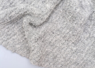 cozy grey knitted textured scarf . top view of a baktus winter scarf. winter outfit. trendy acsessories for women. selective focus